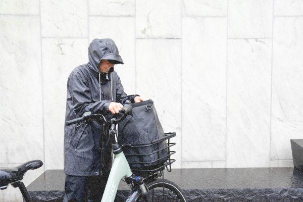 A closeup at a bag inside of a basket, a woman is looking iside of it.