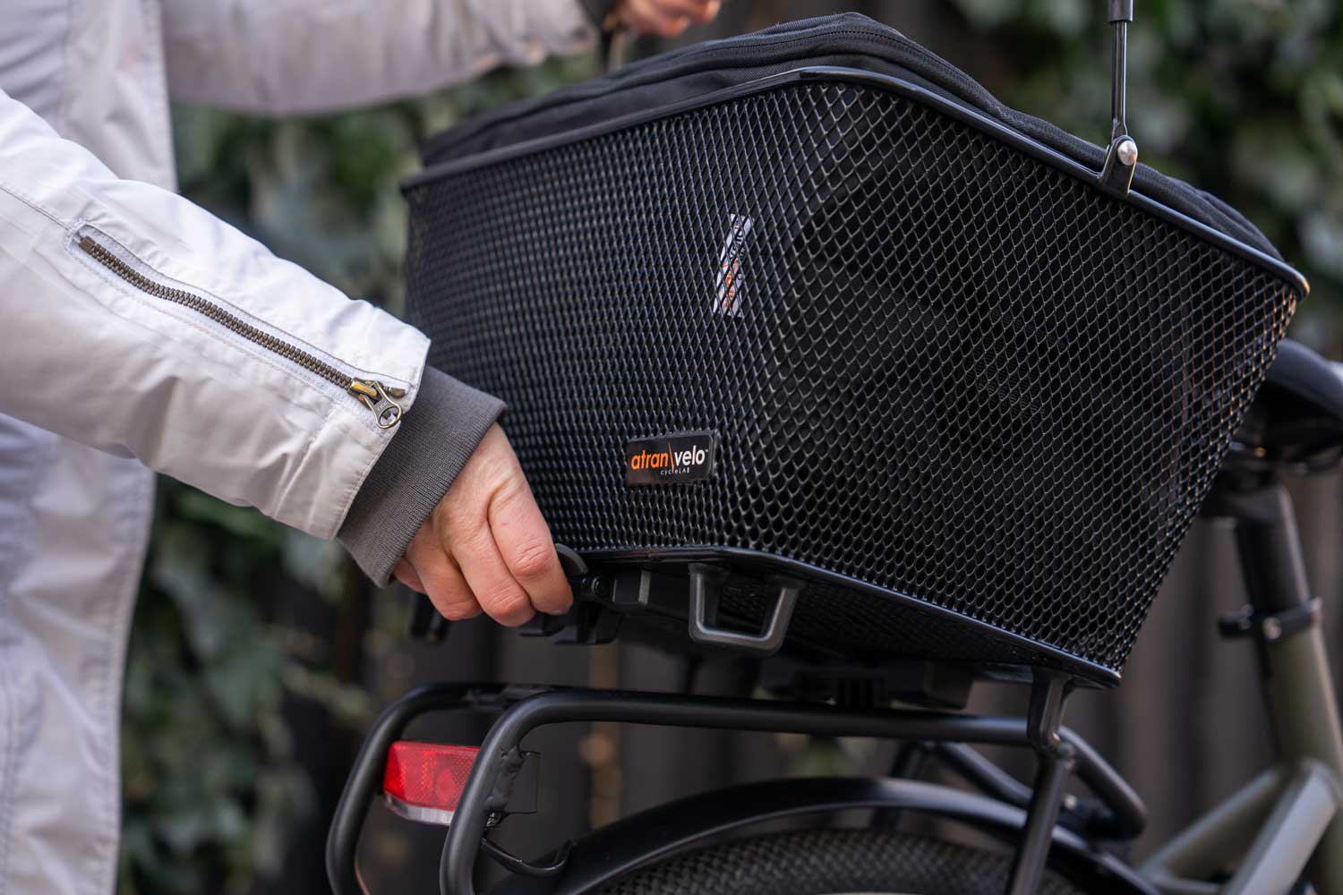 A basket with an infill, in the background you can see some greens and a black fence