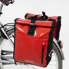 Two red travel bags on bicycle