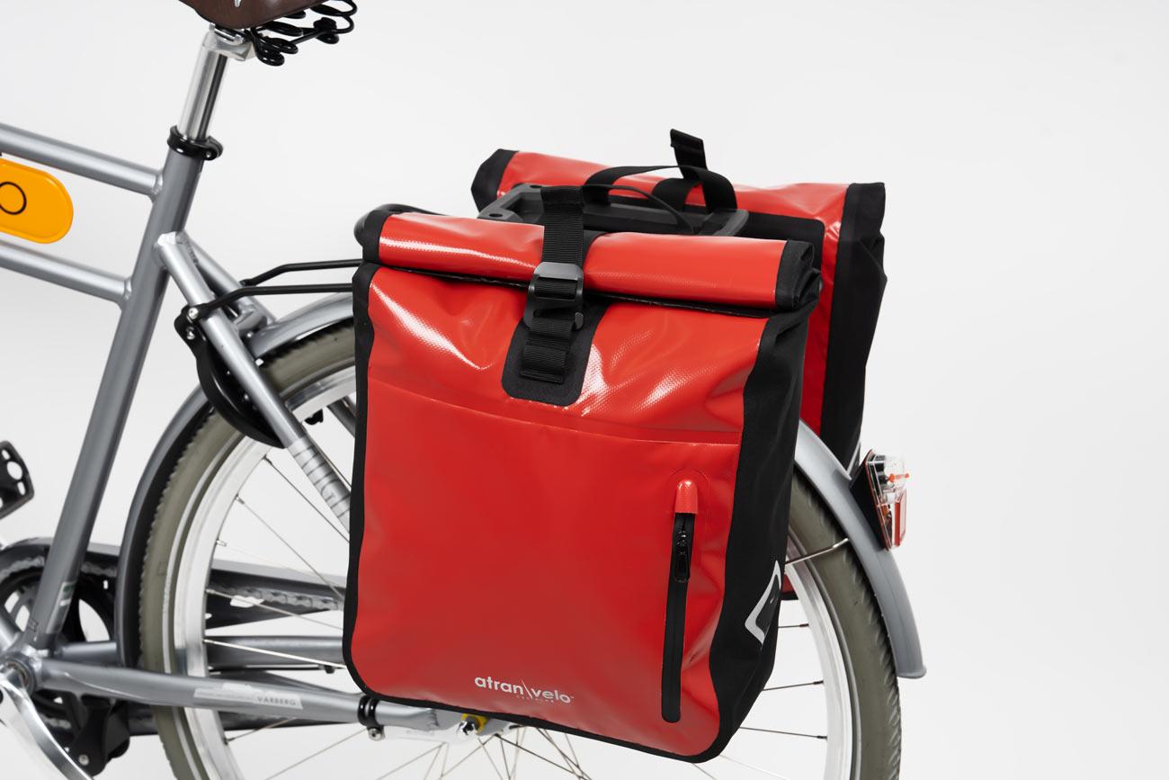 Two red travel bags on bicycle