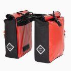 Two red travel bags with a triple-x adaptor