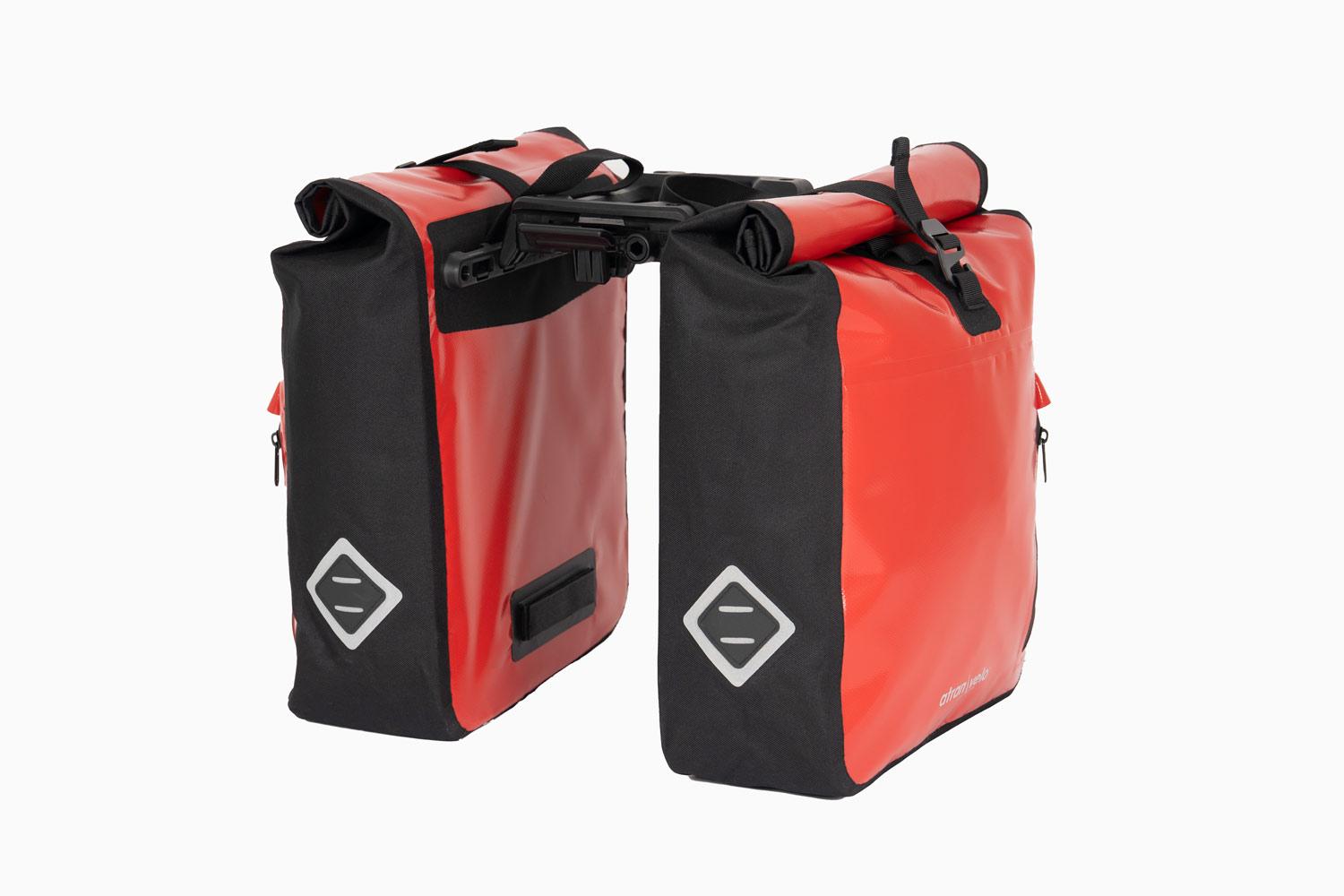 Two red travel bags with a triple-x adaptor