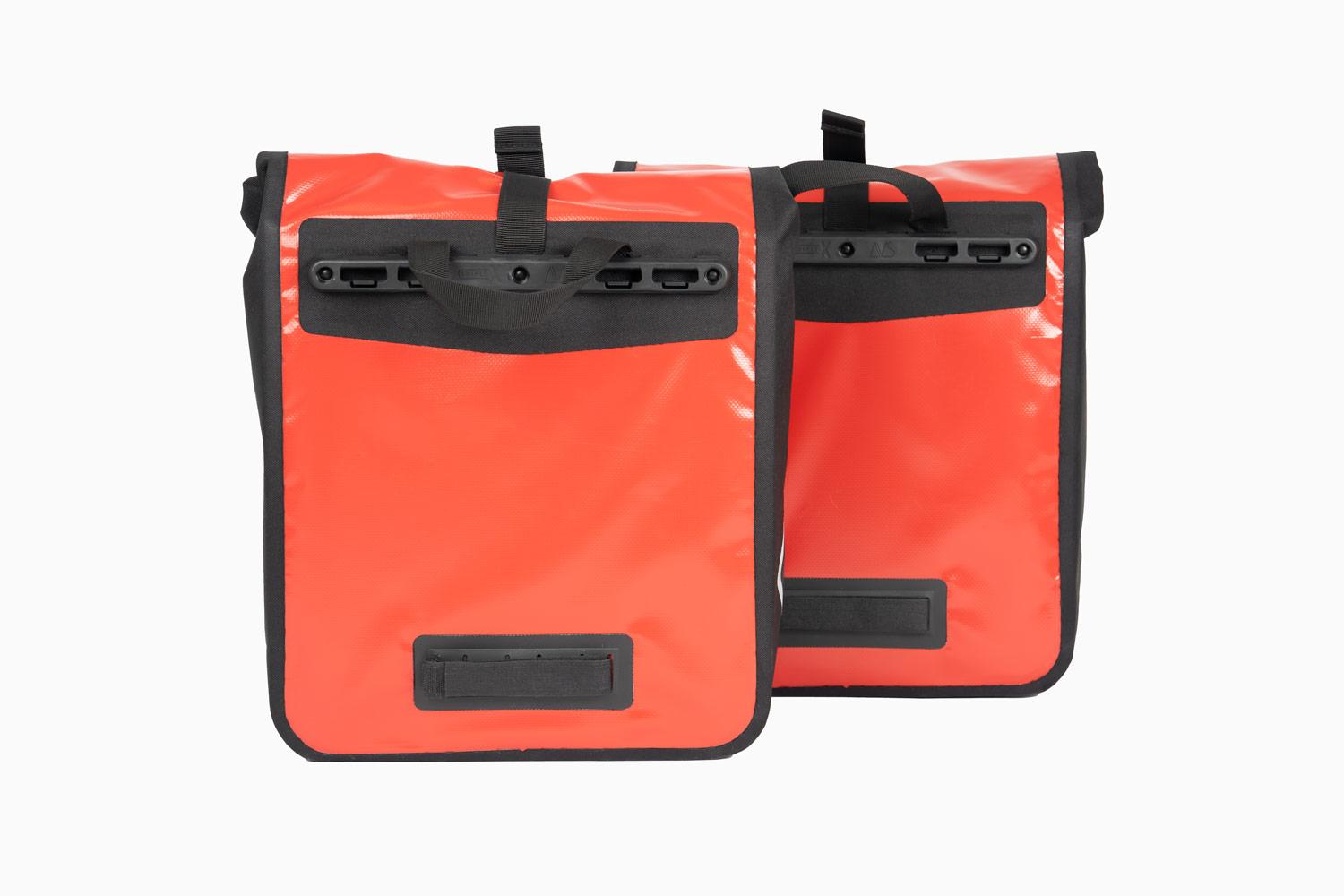 Two red travel bags from behind