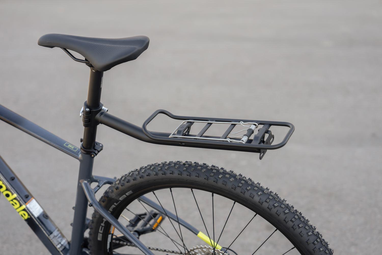A seatpost carrier outside with concrete in the background