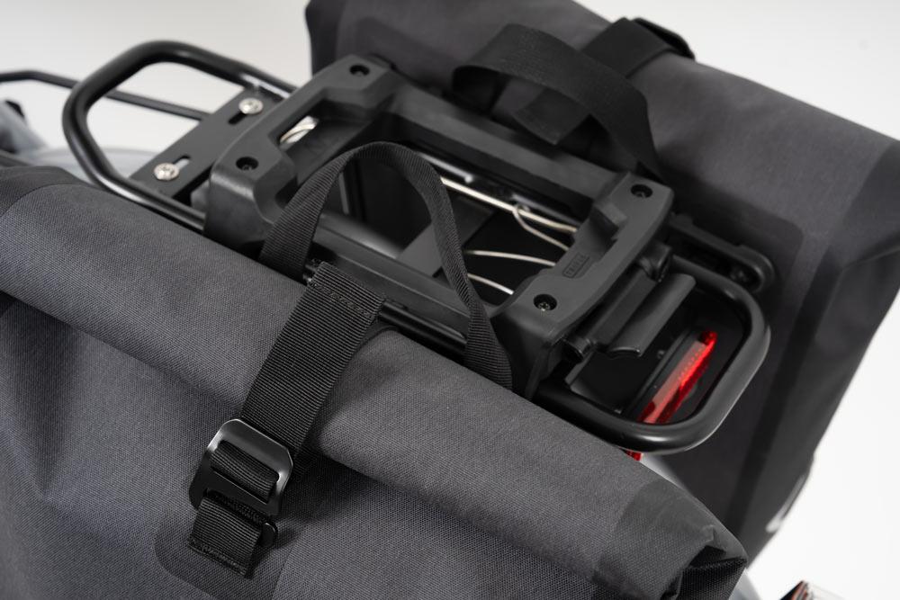 Closeup on two black bags on a rear carrier in a studio