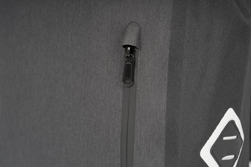 A closup on a black bag on a little sidepocket on the front