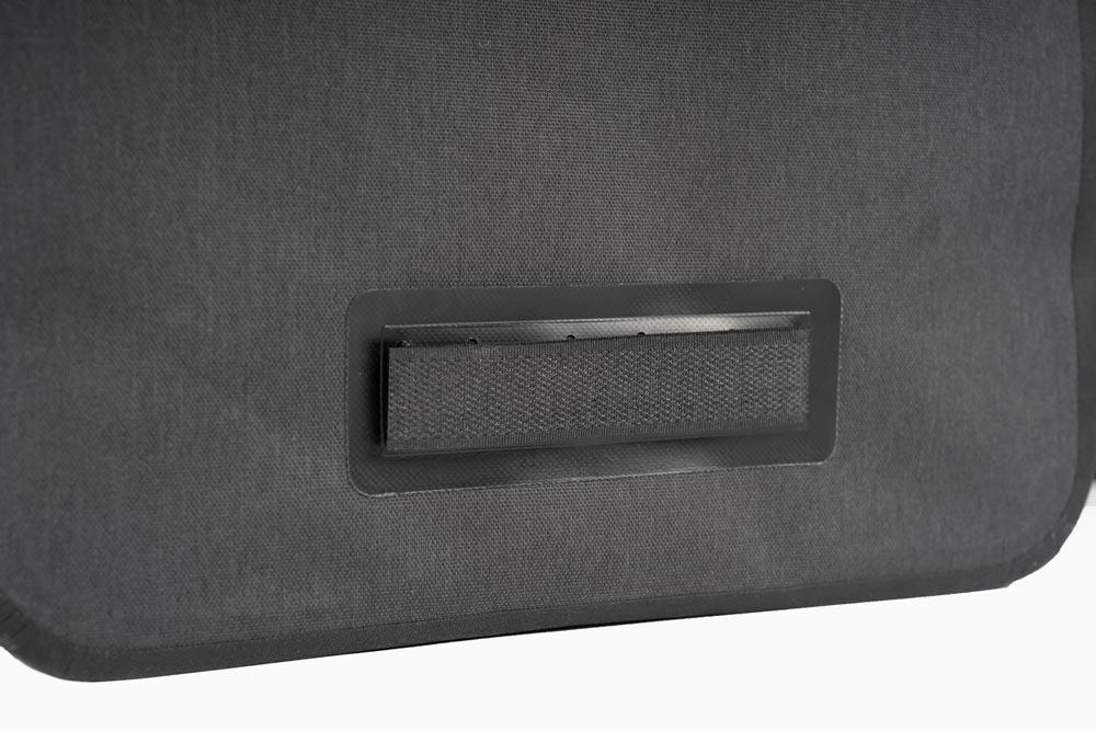 Close up on a velcro strap on a black bag