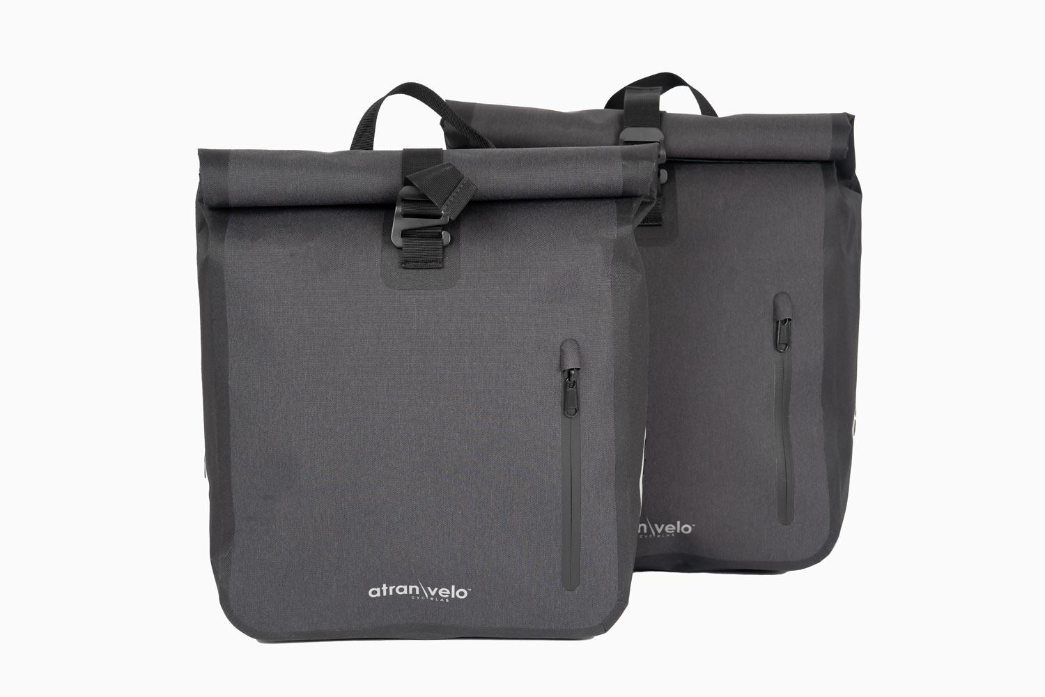 Two dark grey side bags in a studio