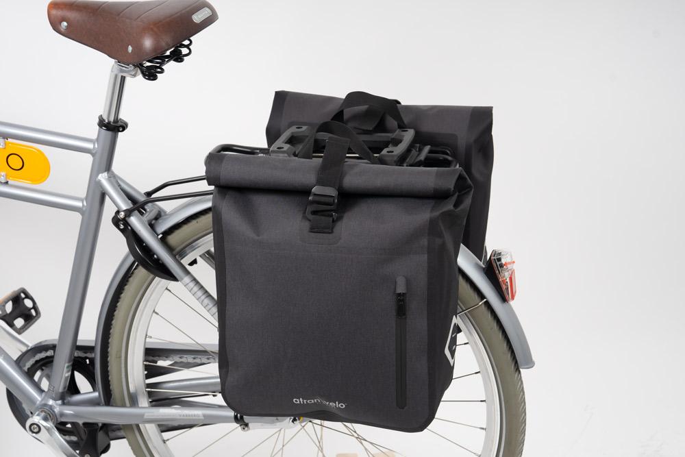 Two black bags on a rear carrier in a studio