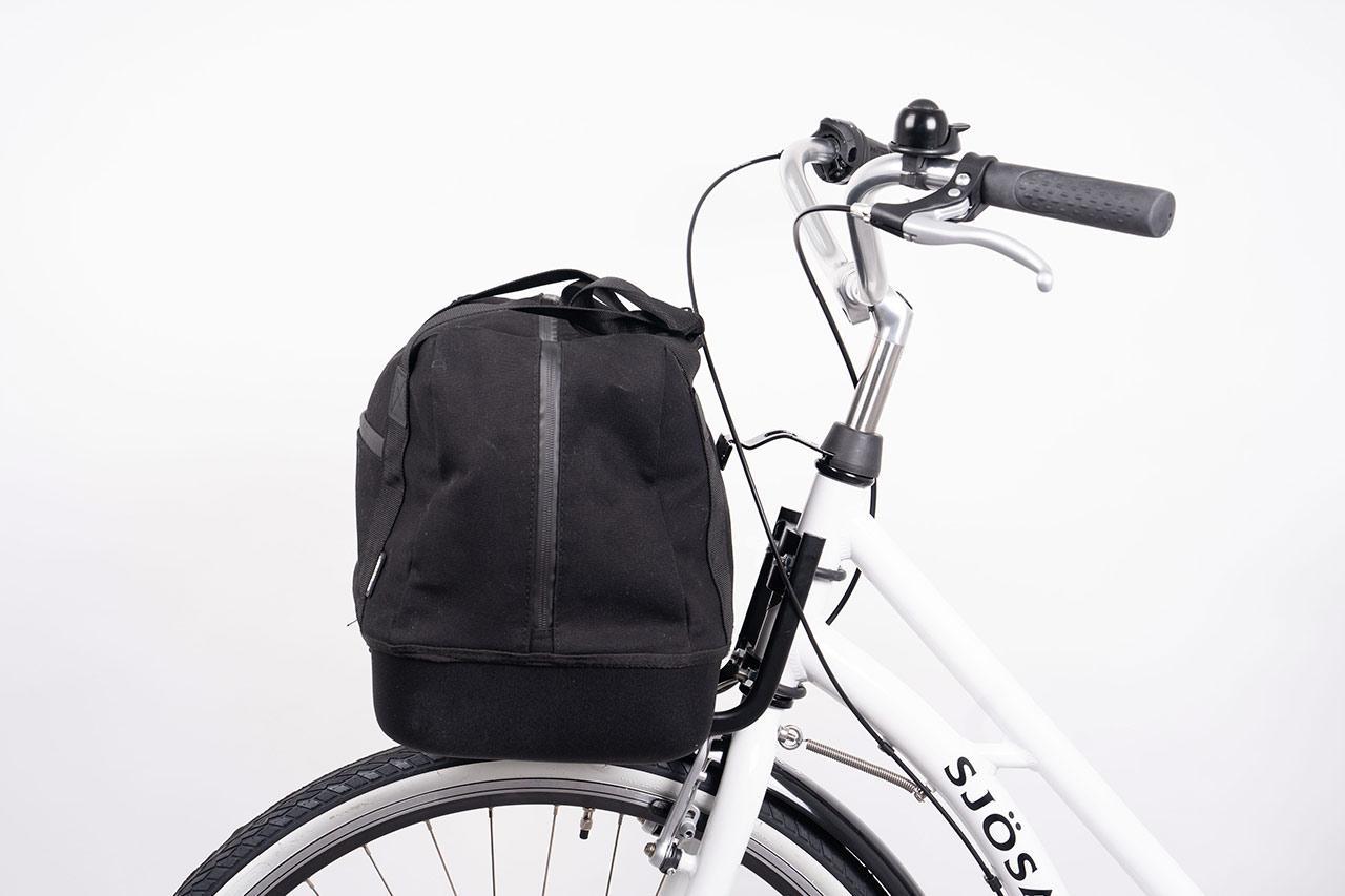 A black topbag in a studio on a bike
