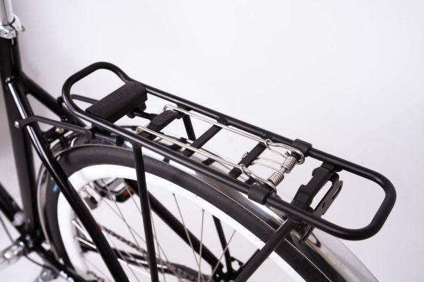 A back carrier with a spring clamp on a bicyclle