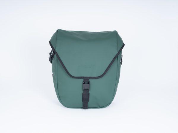 A green sidebag in a studio