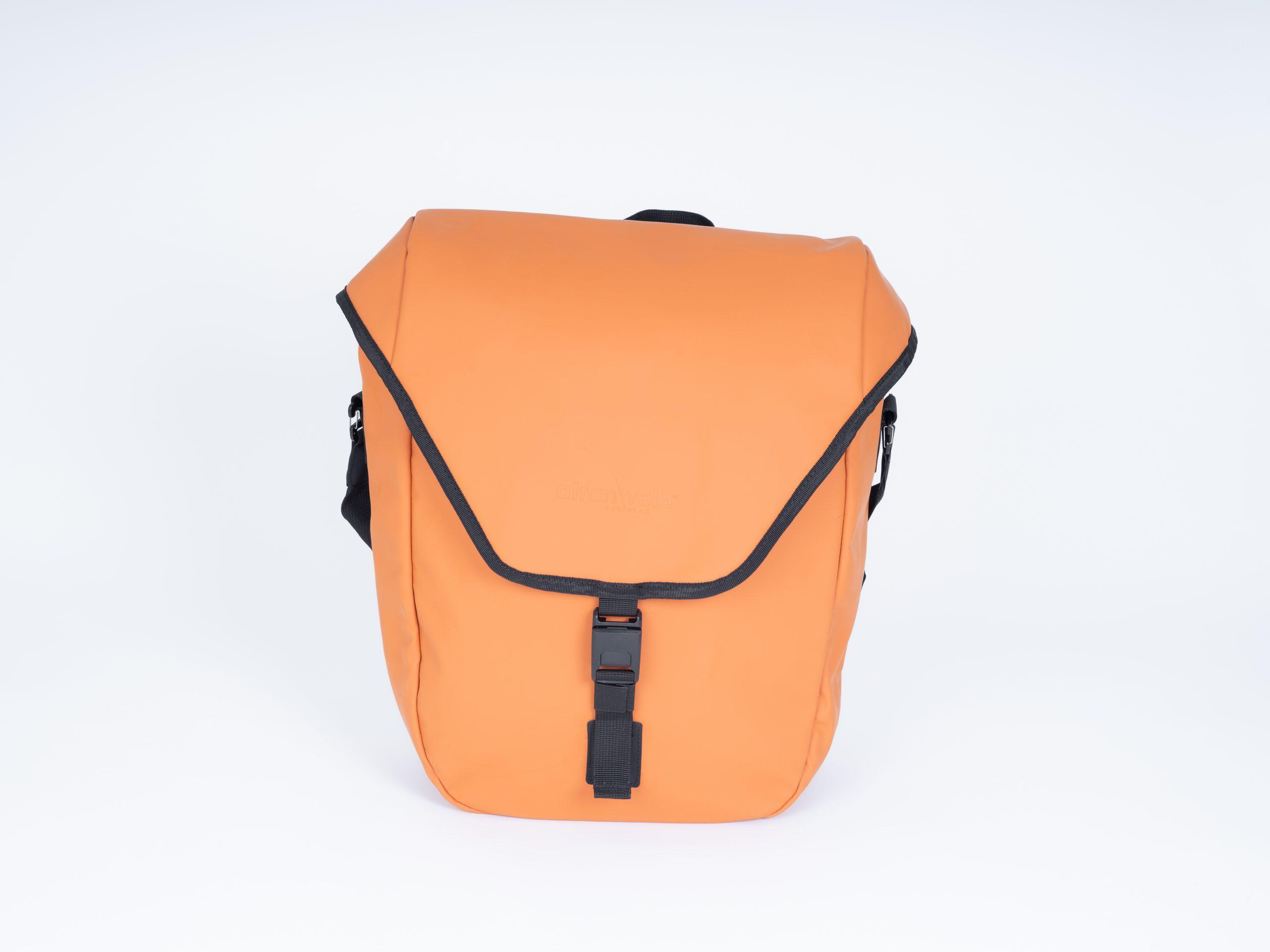 An orange sidebag in a studio