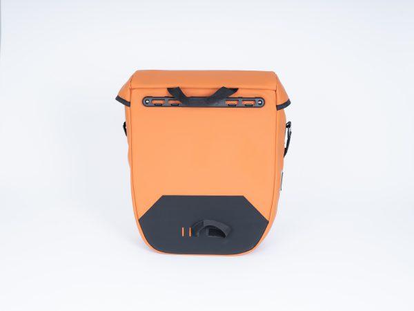 An orange sidebag in a studio