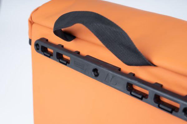 An orange sidebag in a studio