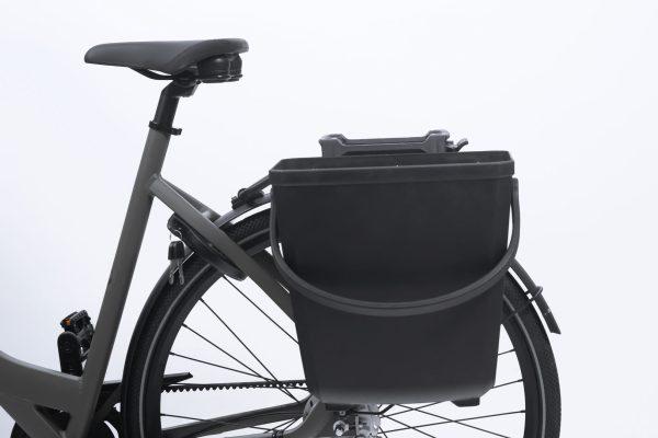 black baskets on the side of a rear carrier in a studio