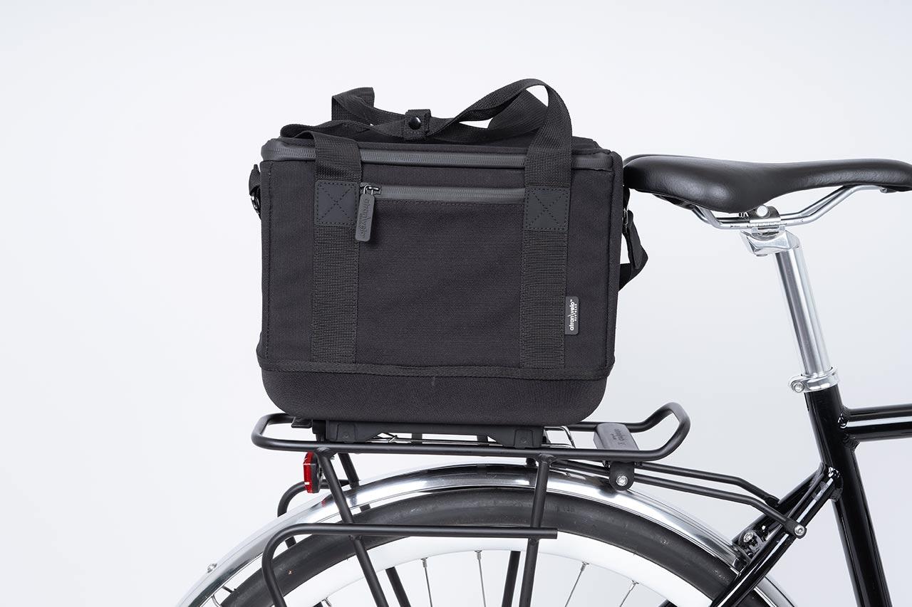 A black topbag in a studio on a bike