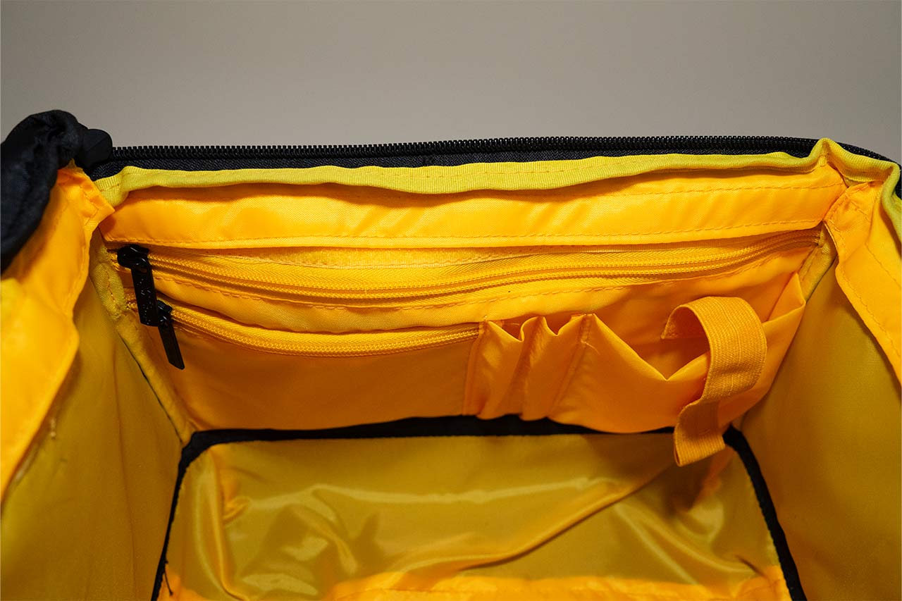 A yellow inside of a bag with pockets