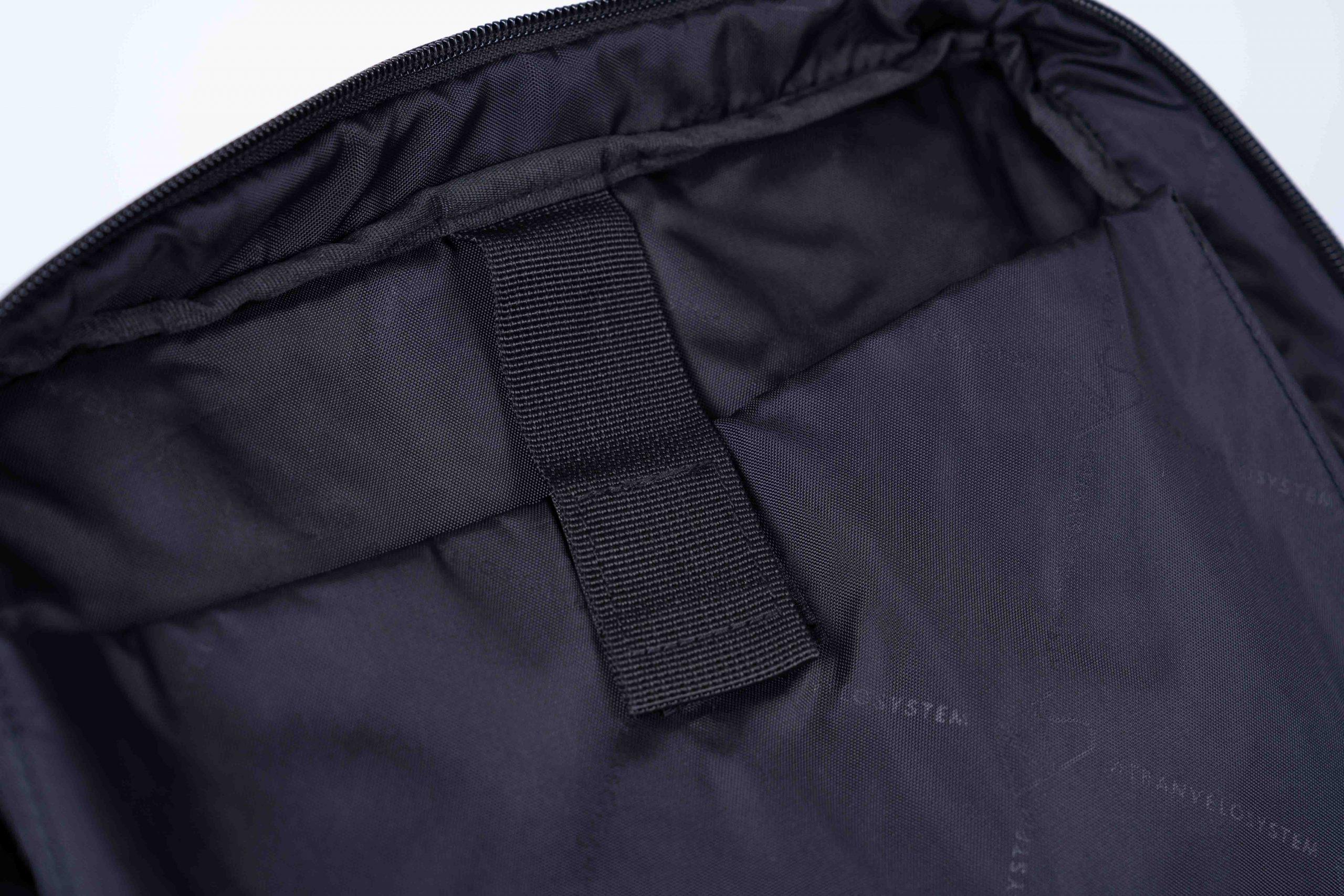 Inside of a black bag show a closeup on the laptop pocket