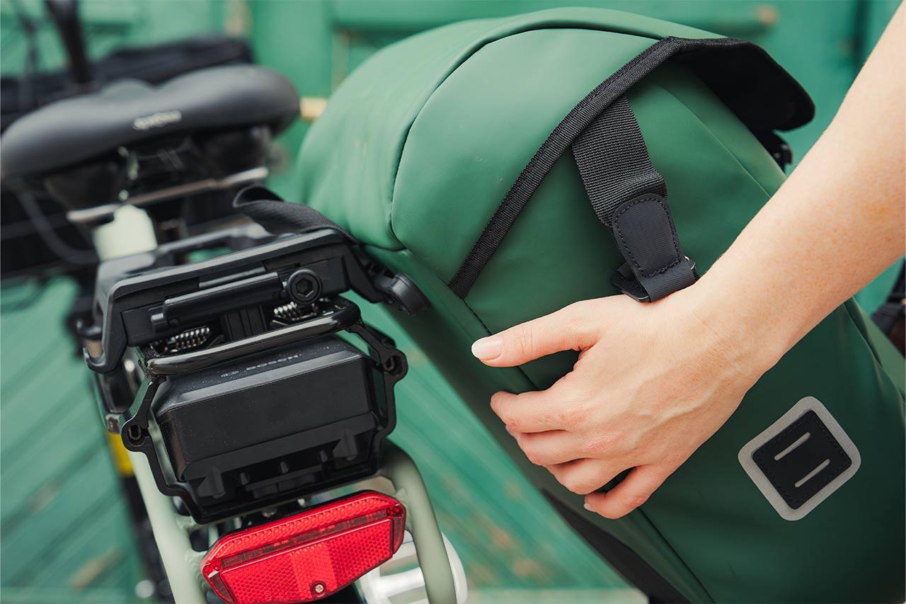 A green bike, green sidebag and a green door