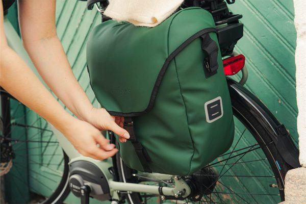 A green bike, green sidebag and a green door