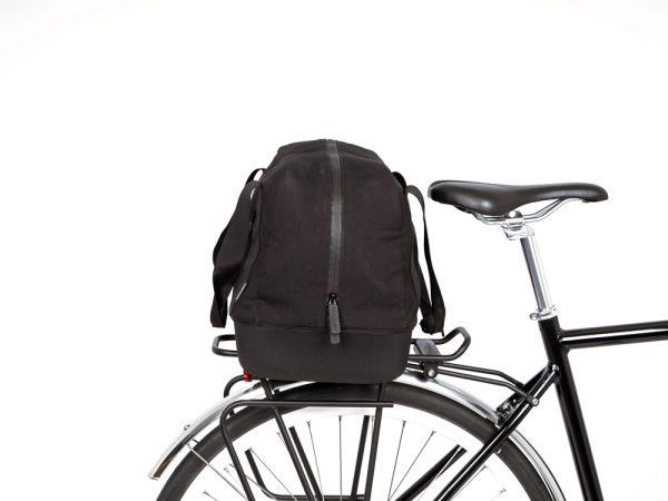 A black topbag in a studio on a bicycle