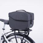 A studiopicture at a grey topbag from the side at a bike