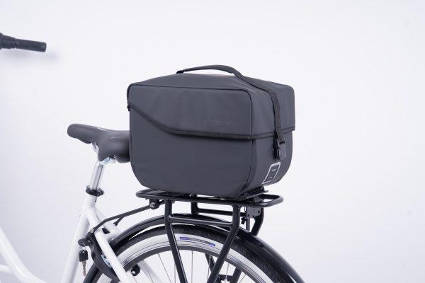 A studiopicture at a grey topbag from the side at a bike