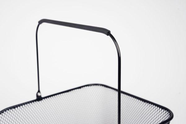 Black net basket in a studio, closeup on the handle