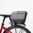 Black net basket in a studio on a red bicycle