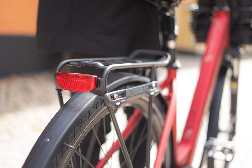 Closeup ona avs side unibar on a red bicycle on the rear carrier.