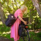 Woman in pink dress lifts off a commuter top wp outside